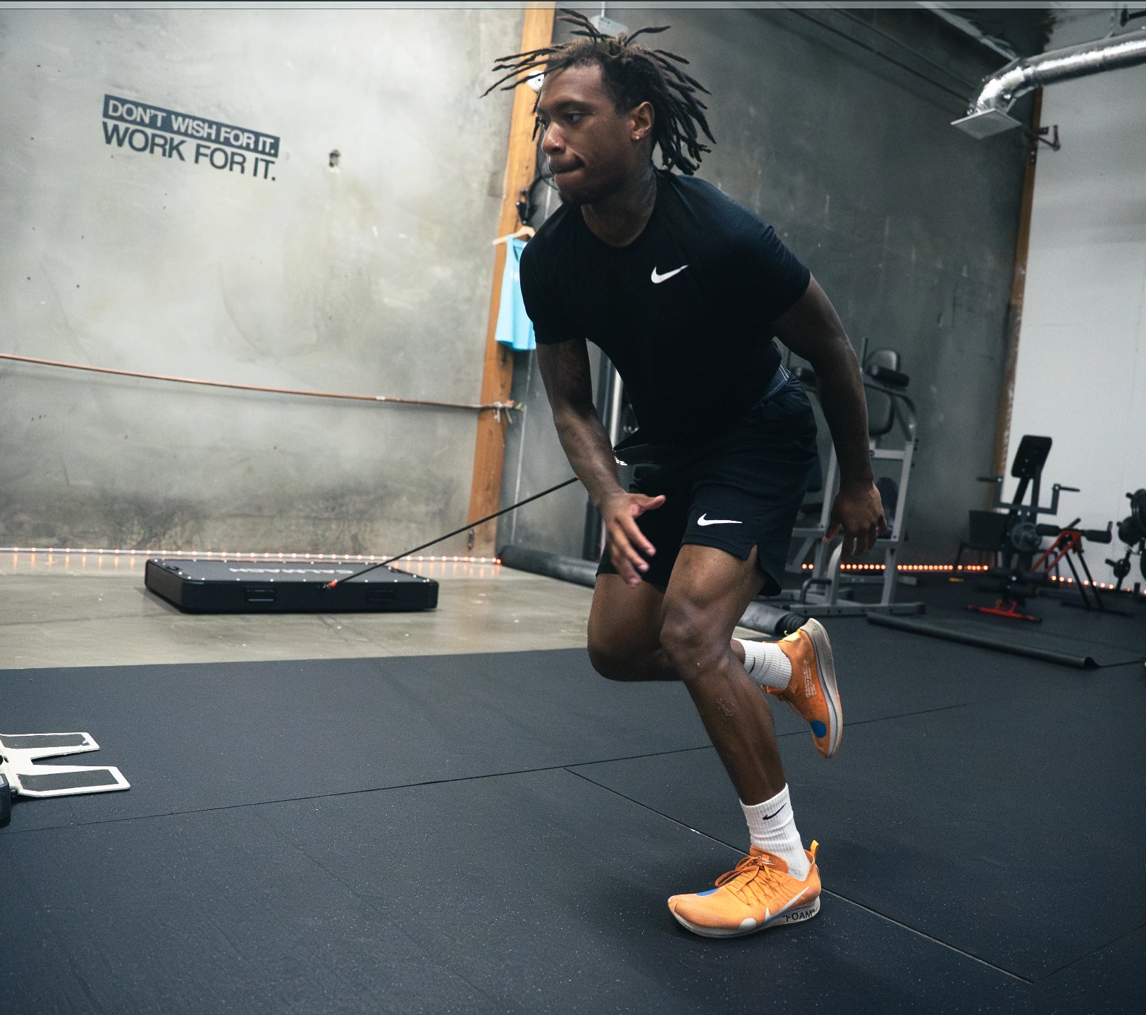 Athlete driving forward against KiNTRA bands